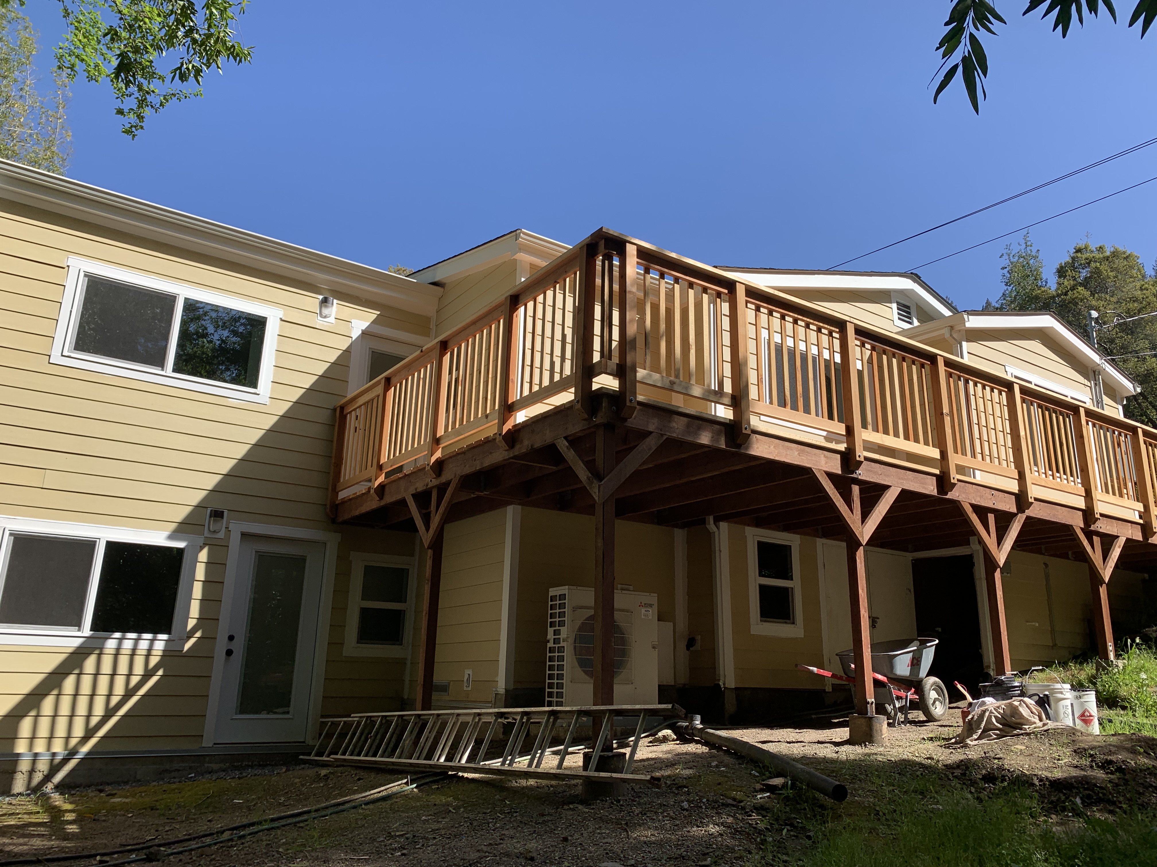 Finished two-story exterior and deck after heavy restoration
